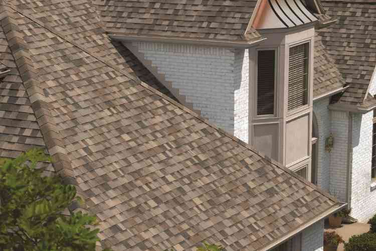Owens Corning TruDefinition® Duration® Designer Sand Dune_preferred contracor_ residential roofing_lady on the roof (750 x 500 px)