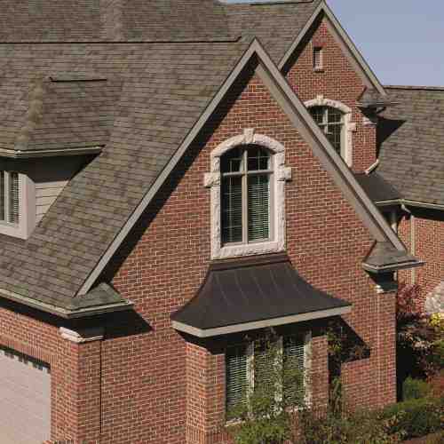 Owens Corning TruDefinition® Oakridge® Driftwood_ resdidential roofing_lady on the roof